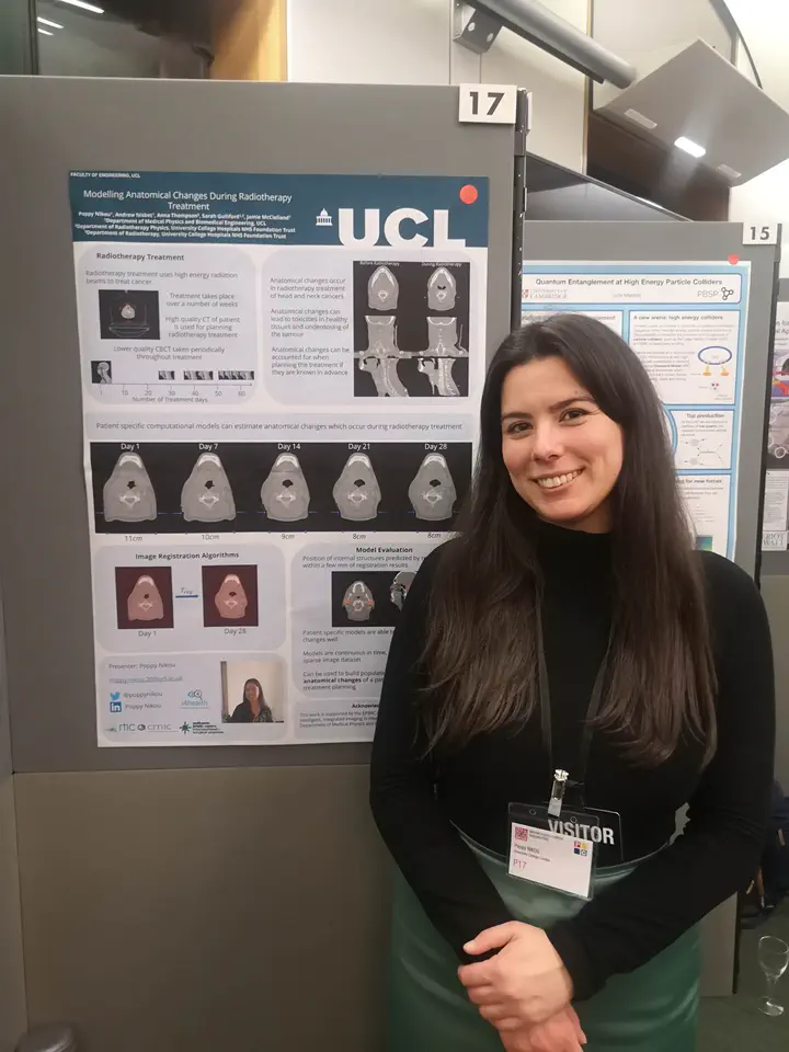 RTIC PhD Student Poppy Nikou smiling, standing in front of her "Modelling anatomical changes" poster that is being displayed on a board.